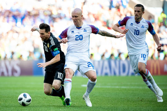 Lionel Messi of Argentina and Emil Hallfredsson of Iceland