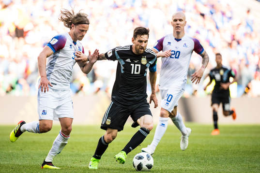Lionel Messi of Argentina in action with of Iceland Birkir