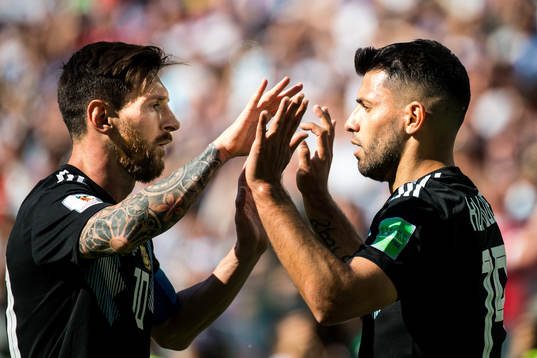 Lionel Messi celebrates with Sergio Aguero