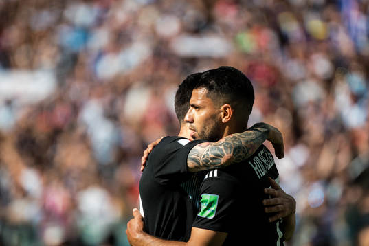 Lionel Messi celebrates with Sergio Aguero
