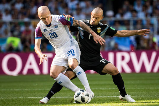 Emil Hallfredsson of Iceland in action with Javier