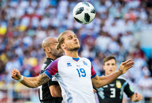 Rurik Gislason of Iceland and Javier Mascherano of Argentina