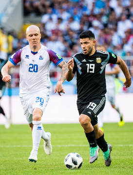 Emil Hallfredsson of Iceland and Sergio Aguero of Argentina