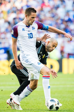 Gylfi Sigurdsson of Iceland and Javier Mascherano of