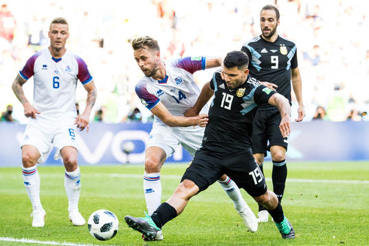 Sergio Aguero of Argentina and Kari Arnason of Iceland