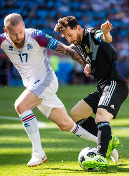 Aron Gunnarsson of Iceland and Lionel Messi of Argentina