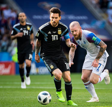 Lionel Messi of Argentina and Aron Gunnarsson of Iceland
