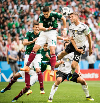 Javier Hernandez of Mexico and Thomas Müller of Germany