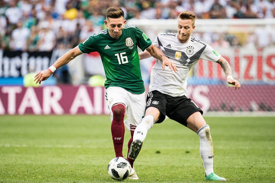 Hector Herrera of Mexico in action with Marco Reus of