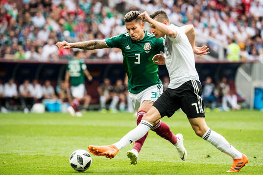 Carlos Salcedo of Mexico in action with Julian Draxler of