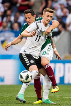 Marco Reus of Germany in action with Andres Guardado of