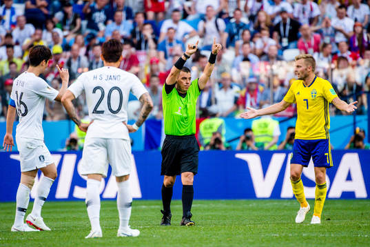 Referee Joel Aguilar reviews a penalty incident using VAR