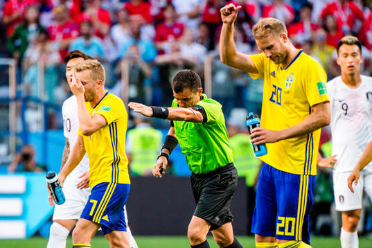 Referee Joel Aguilar reviews a penalty incident using VAR