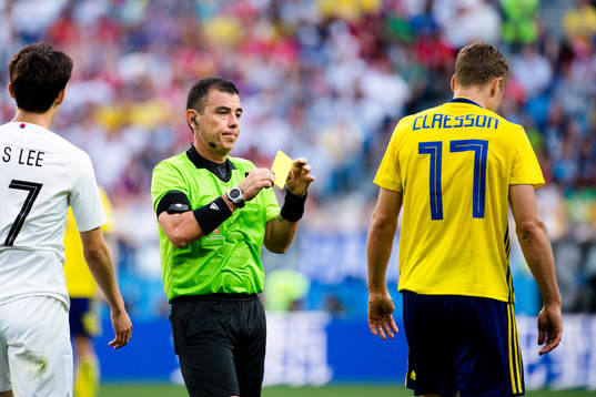 Referee Joel Aguilar and Viktor Claesson of Sweden