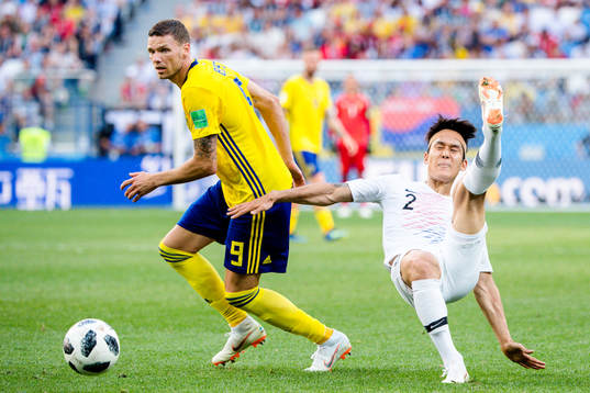 Marcus Berg of Sweden and Yong Lee of South Korea
