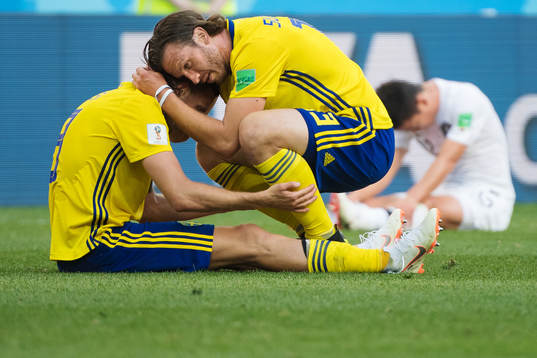 Marcus Berg gets a hug from Gustav Svensson of Sweden