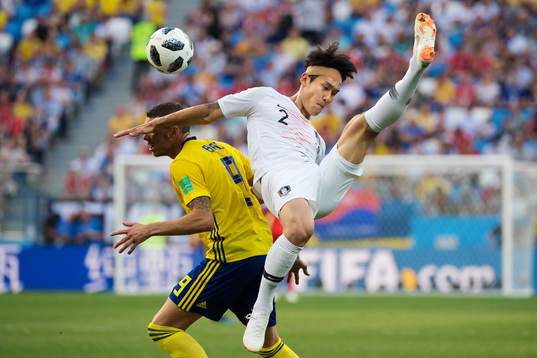 Marcus Berg of Sweden in action against Yong Lee of South