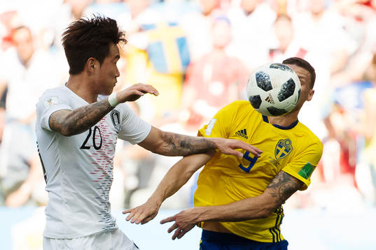 Hyunsoo Jang of South Korea and Marcus Berg of Sweden