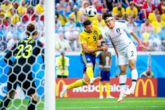 Marcus Berg of Sweden against Yong Lee of South Korea
