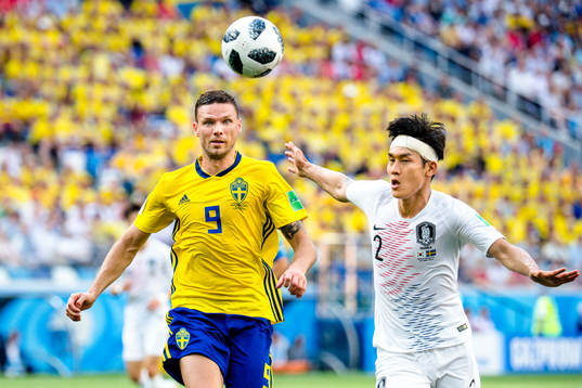 Marcus Berg of Sweden and Yong Lee of South Korea