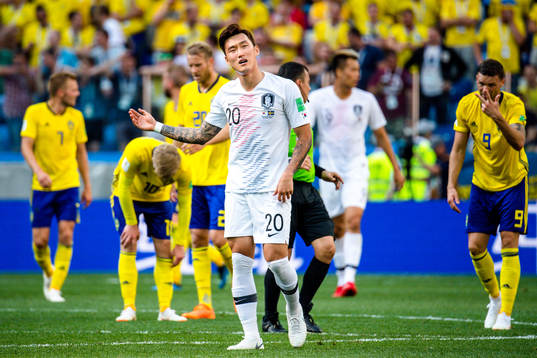 Hyunsoo Jang of South Korea looks dejected