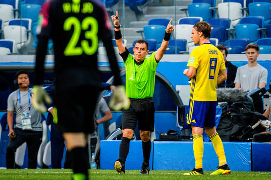 Referee Joel Aguilar reviews a penalty incident using VAR