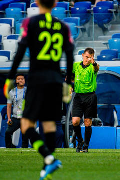 Referee Joel Aguilar reviews a penalty incident using VAR