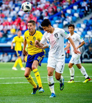 Mikael Lustig of Sweden and Heungmin Son of South Korea