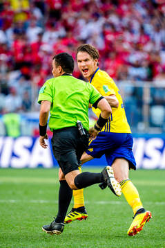 Referee Joel Aguilar and Albin Ekdal of Sweden