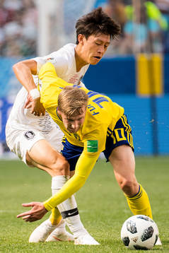 Emil Forsberg of Sweden and Jaesung Lee of South Korea