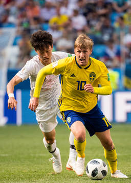 Emil Forsberg of Sweden and Jaesung Lee of South Korea