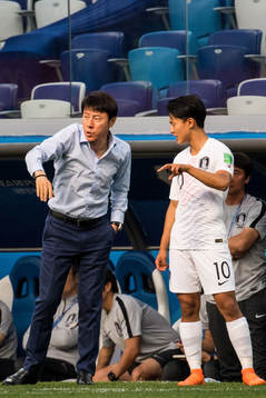 Head coach Shin Tae-Yong and Seungwoo Lee of South