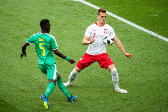 Arkadiusz Milik of Poland and Idrissa Gana Gueye of Senegal