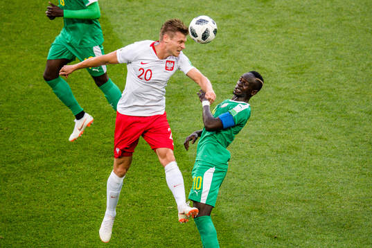 Lukasz Piszczek of Poland and Sadio Mane of Senegal