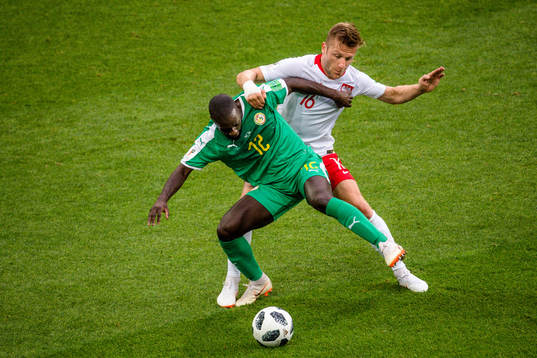 Youssouf Sabaly of Senegal and Jakub Blaszczykowski of