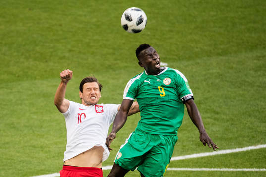 Grzegorz Krychowiak of Poland and Mame Diouf of Senegal