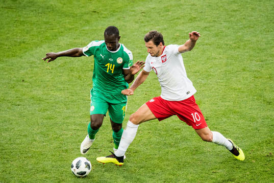 Moussa Konate of Senegal and Grzegorz Krychowiak of Poland