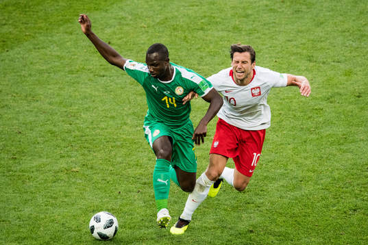 Moussa Konate of Senegal and Grzegorz Krychowiak of Poland