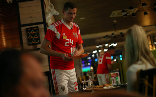 Fotboll, VM A waiter wearing a Russia team football kit