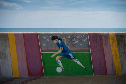 A mural with a football player
