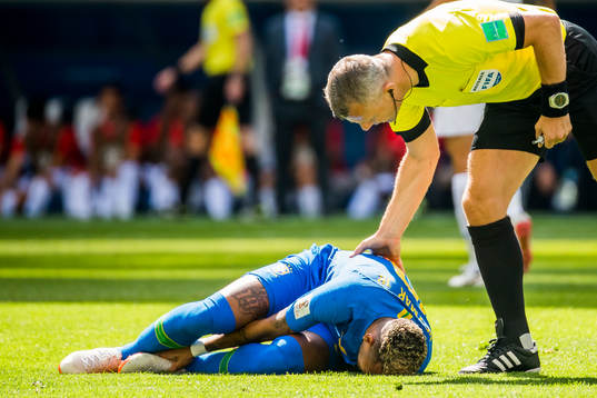 Neymar of Brazil lies down with an injury