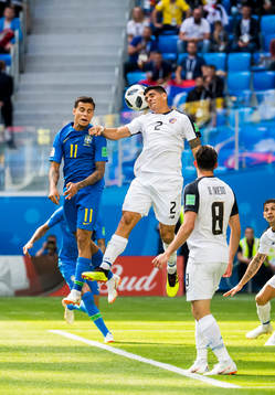 Philippe Coutinho of Brazil and Johnny Acosta of Costa Rica