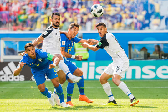Thiago Silva and Roberto Firmino of Brazil compete for the