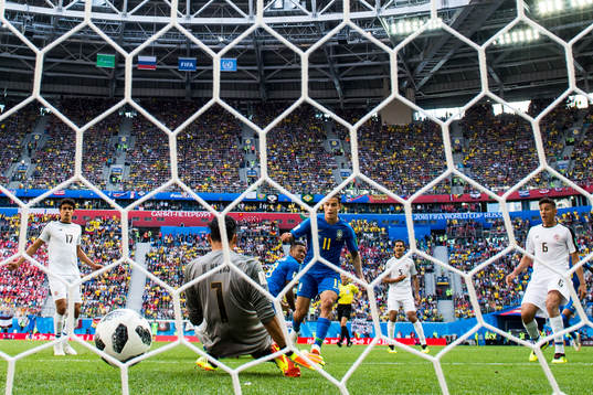 Philippe Coutinho of Brazil scores 1-0 behind goalkeeper
