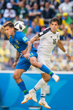 Philippe Coutinho of Brazil in action with Cristian Gamboa