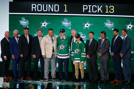 Ty Dellandrea of Canada poses with team representatives