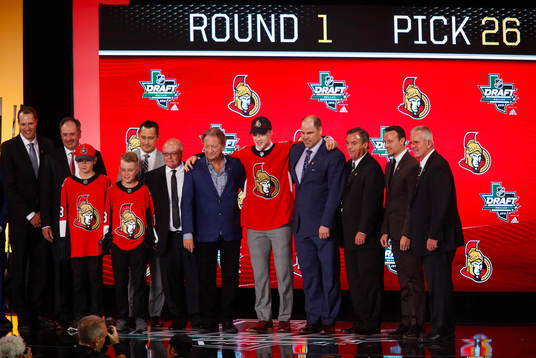 Jacob Bernard of Canada poses with team representatives