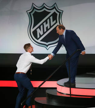 Andrei Svechnikov of Canada is greeted by NHL Commissioner