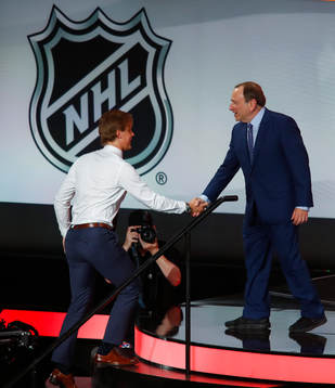Adam Boqvist of Sweden is greeted by NHL Commissioner Gary