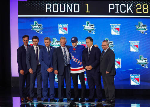 Nils Lundkvist of Sweden poses with team representatives